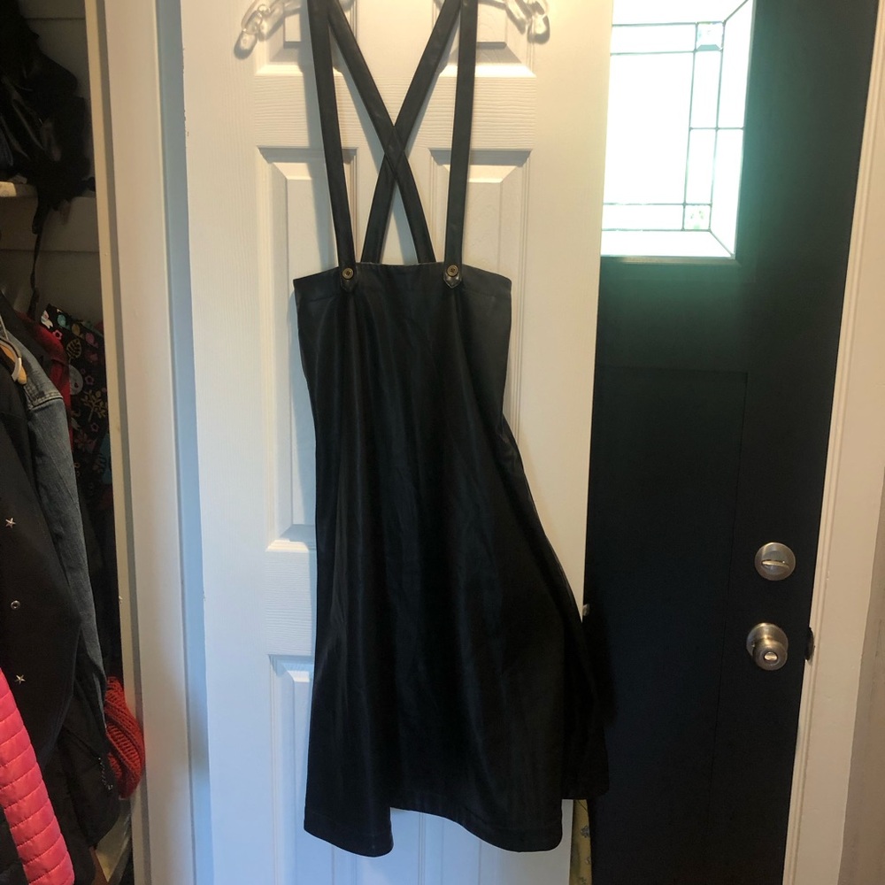 Anthropologie long black faux leather overall type skirt.